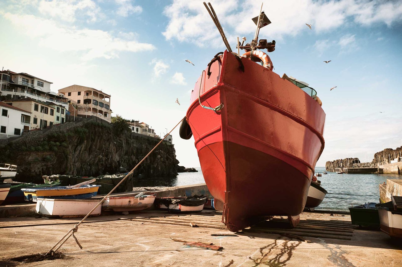 Red anglers boat in Camara de Lobos pier