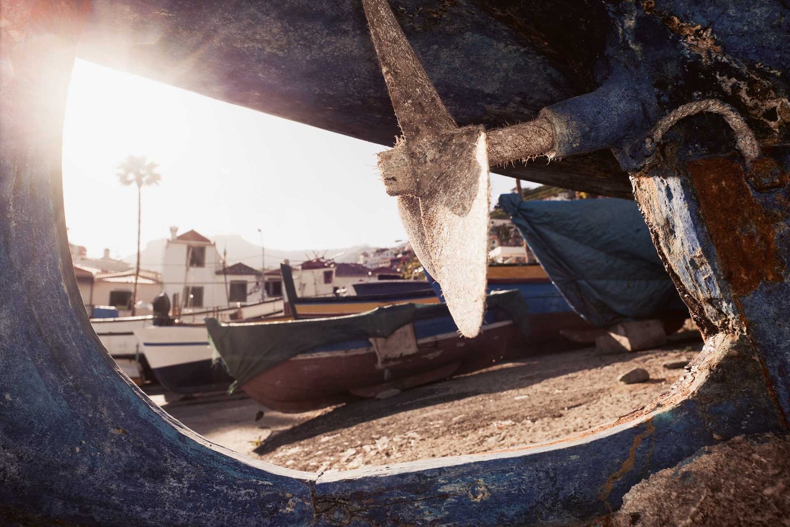 Old fishermen boats on ground in Camara de Lobos at sunset