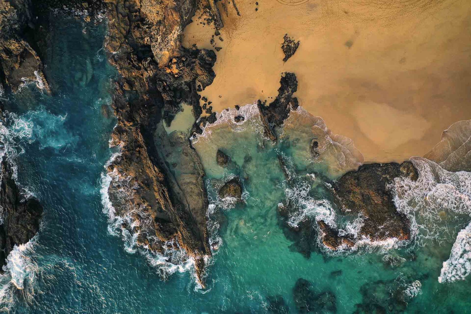 Aerial top view of water and sand